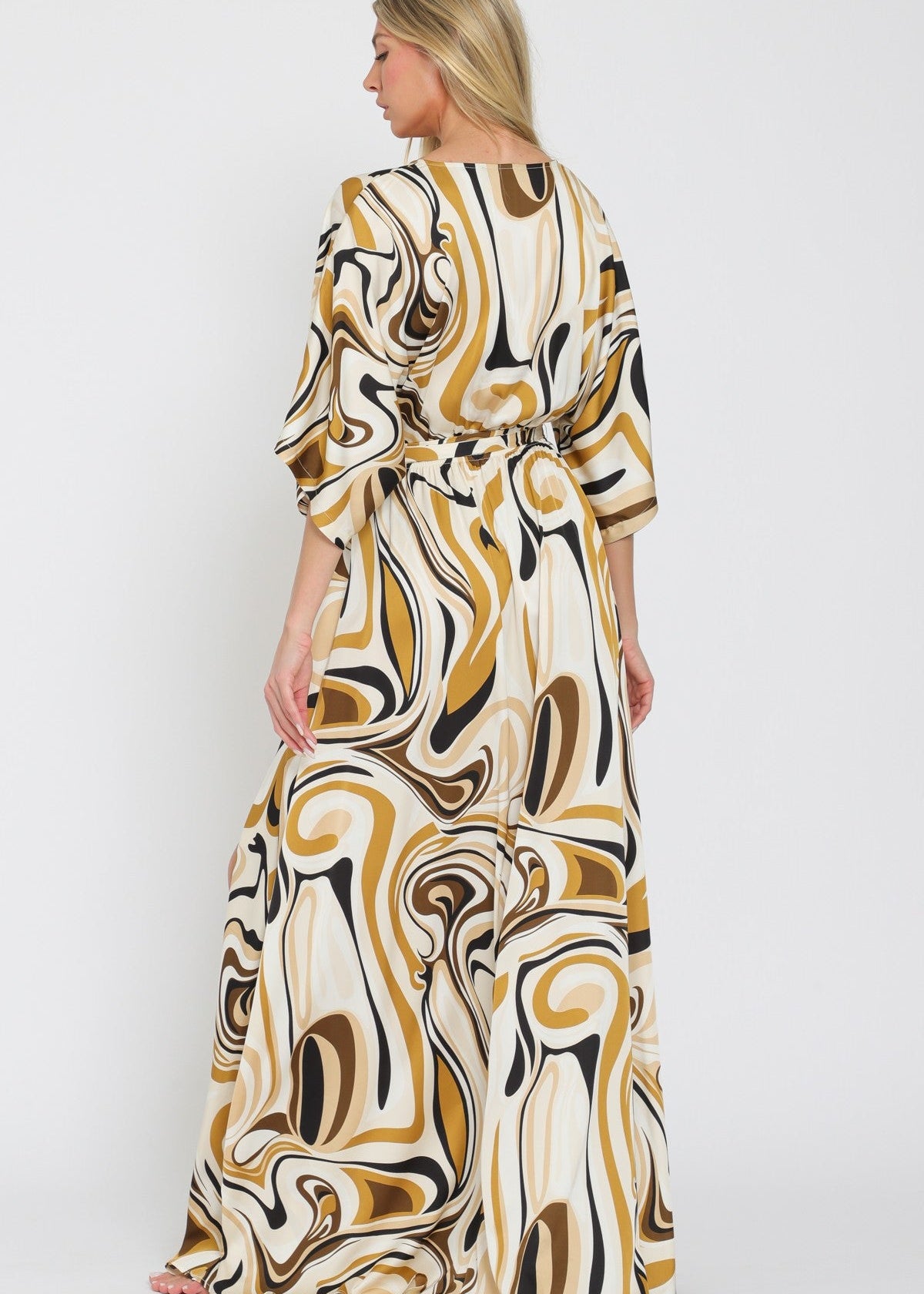 Woman wearing a patterned dress on a white background