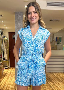 Blue and white multi print sleeveless v-neck button down romper with elastic back and self tie belt and side pockets.&nbsp;