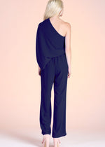 Load image into Gallery viewer, Navy textured solid slouchy one shoulder jumpsuit. The elastic-lined waist and pull-on closure makes this piece both comfortable and easy to wear day to night.
