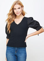 Load image into Gallery viewer, Black poplin sleeve knit top. This style features bodice in ribbed knit, a classic V neckline, and &amp; poplin short sleeves with cuff and tie detail.
