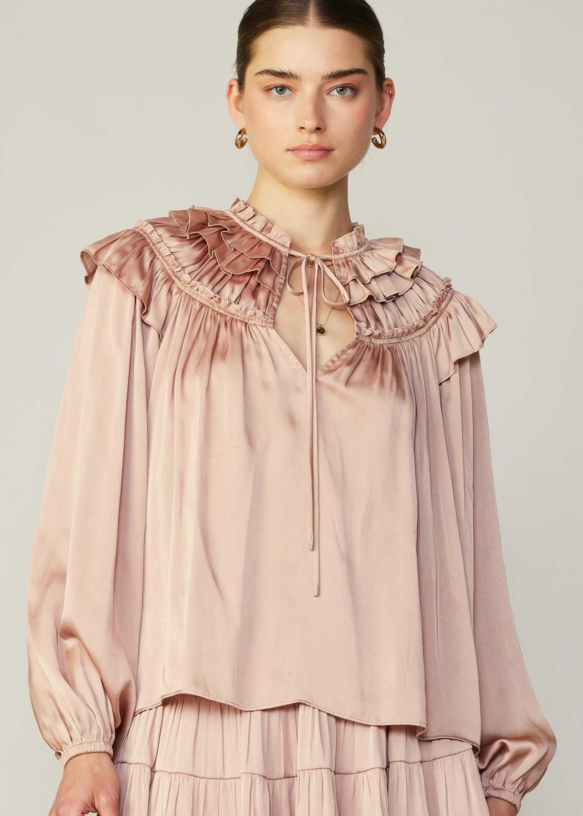 Faded blush cape style shoulder ruffles long sleeve blouse with split neck.