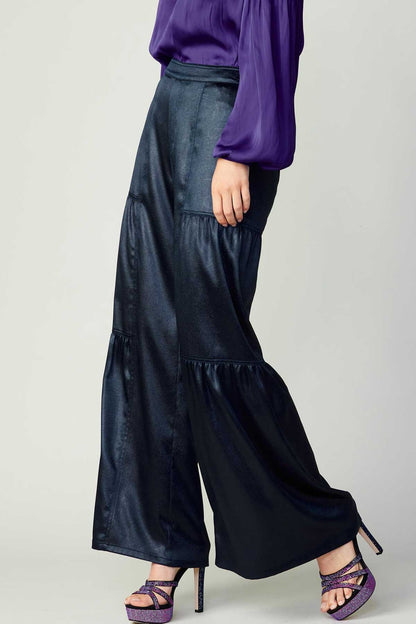 Navy tiered wide-leg pants with elastic at the back waist.