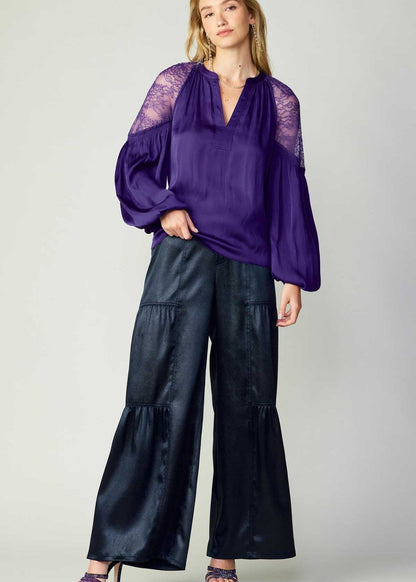 Navy tiered wide-leg pants with elastic at the back waist.
