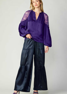 Navy tiered wide-leg pants with elastic at the back waist.