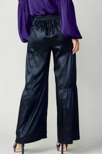 Navy tiered wide-leg pants with elastic at the back waist.