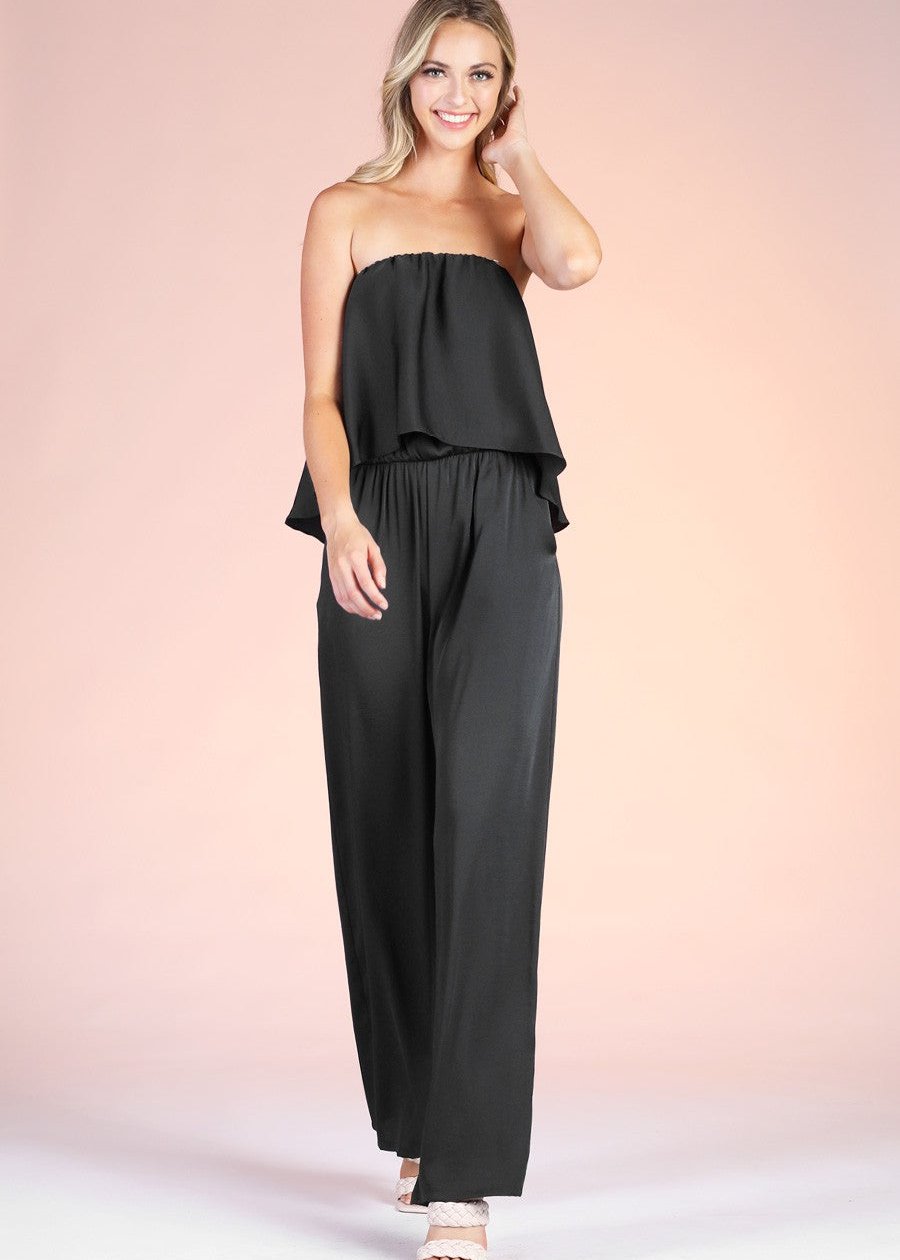 Black washed silk cascade strapless jumpsuit. Features a strapless pleated top and flowy pant.