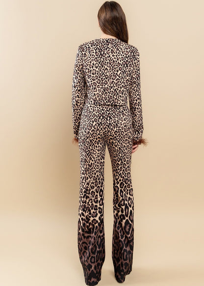 Featuring an all over brown zebra print with ombre design, round neckline, feather trimming as well as a pair of matching pants with a high-rise waist and a wide leg.