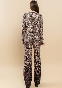 Featuring an all over brown zebra print with ombre design, round neckline, feather trimming as well as a pair of matching pants with a high-rise waist and a wide leg.