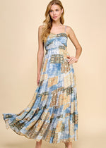Load image into Gallery viewer, Asymmetrical tiered maxi dress with an abstract print. Featuring a smocked top and adjustable spaghetti straps.
