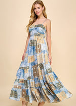 Load image into Gallery viewer, Asymmetrical tiered maxi dress with an abstract print. Featuring a smocked top and adjustable spaghetti straps.
