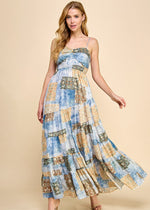 Load image into Gallery viewer, Asymmetrical tiered maxi dress with an abstract print. Featuring a smocked top and adjustable spaghetti straps.
