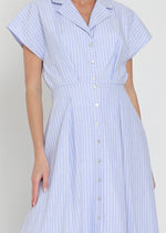 Load image into Gallery viewer, Woman wearing a light blue and white striped dress against a plain background
