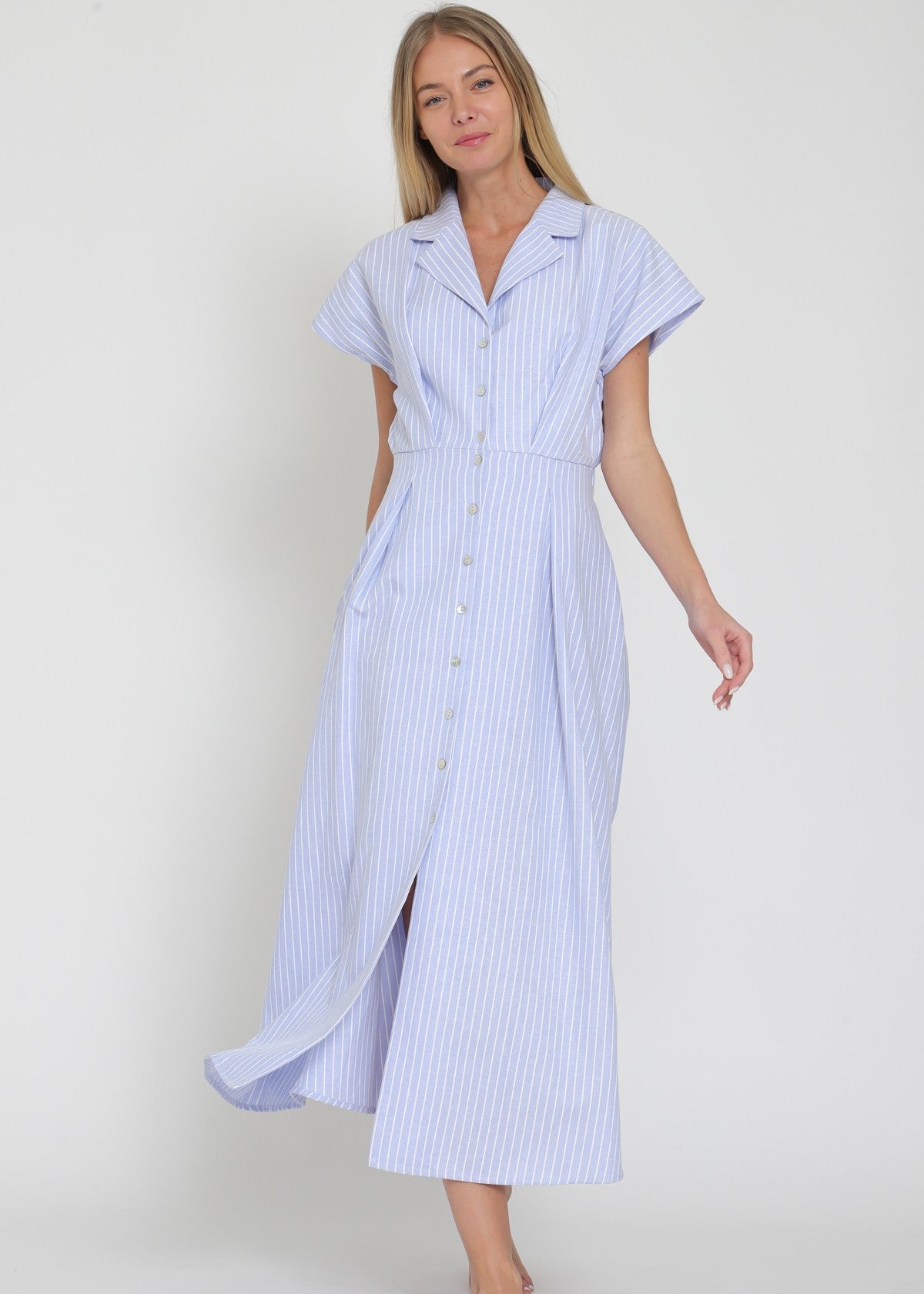 Woman wearing a blue and white striped dress on a plain background