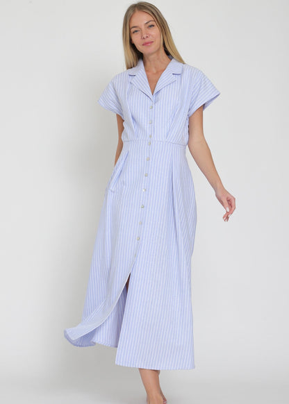 Woman wearing a blue and white striped dress on a plain background