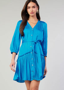 Blue v-neck 3/4 sleeve short button down dress with ruffled detail on skirt.