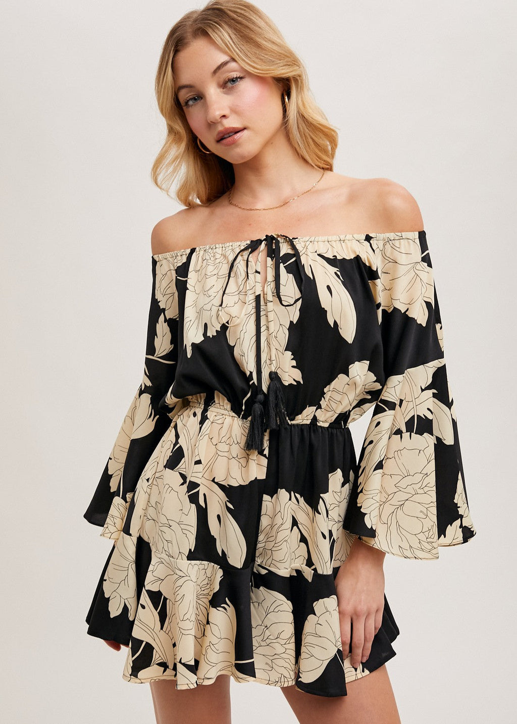 Black floral off the shoulder bell sleeved romper.