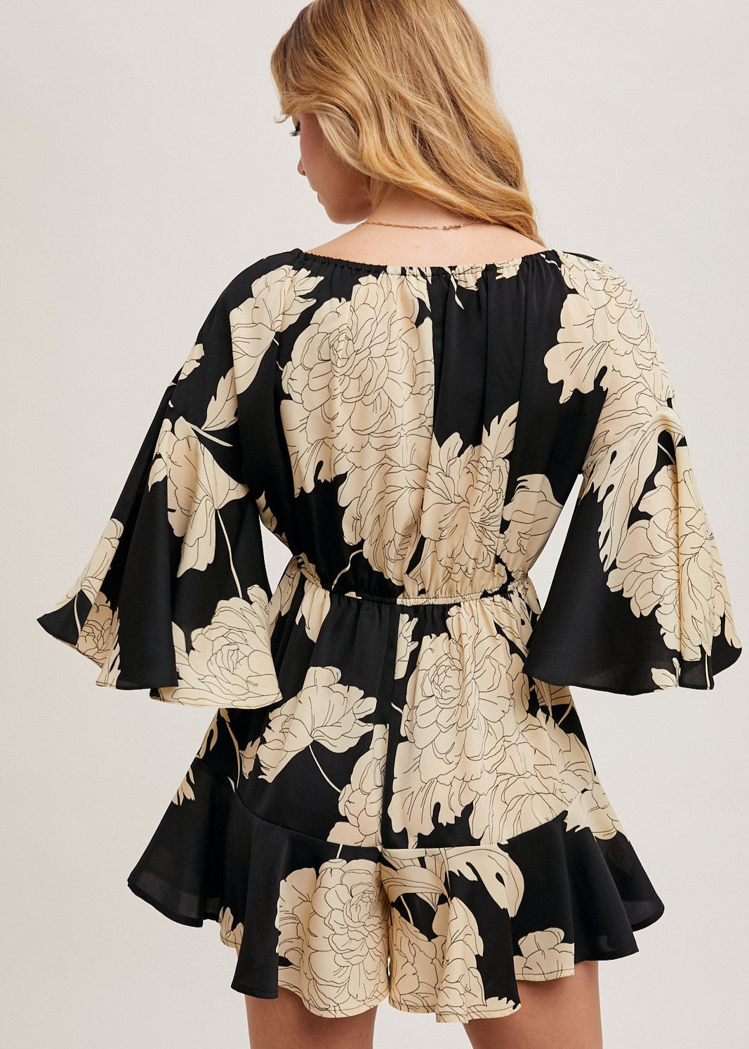 Black floral off the shoulder bell sleeved romper.