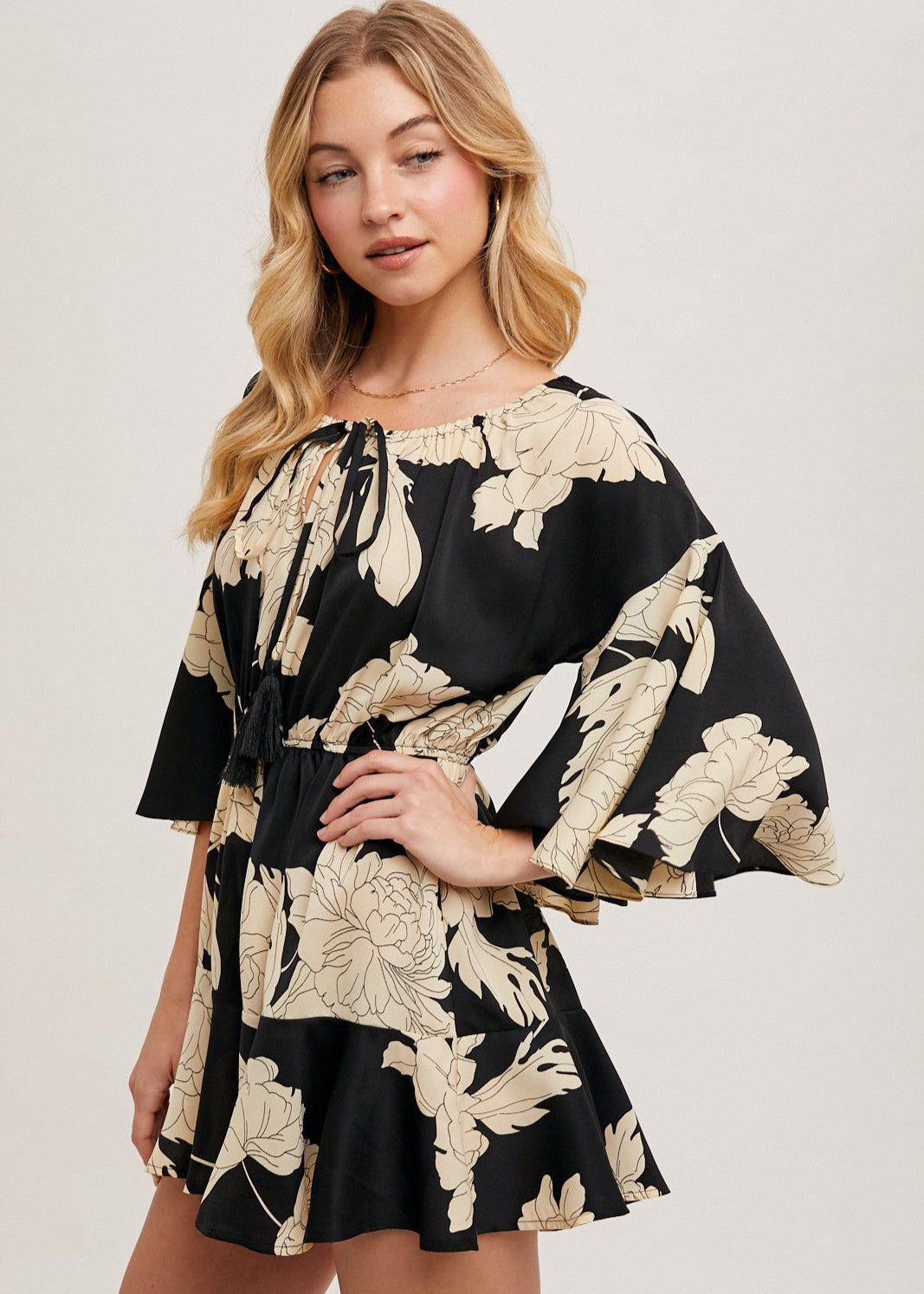 Black floral off the shoulder bell sleeved romper.