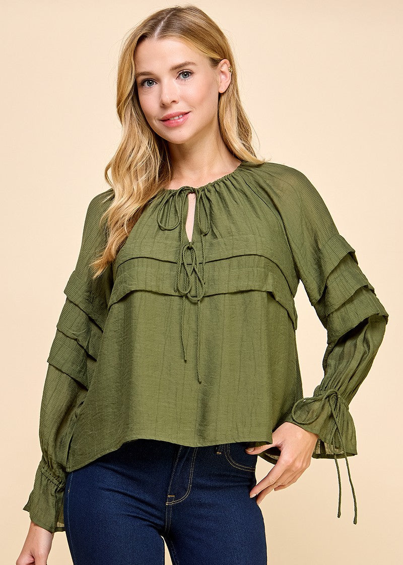 Olive green long sleeve blouse with a ruffle details and adjustable ties on neckline and sleeve.