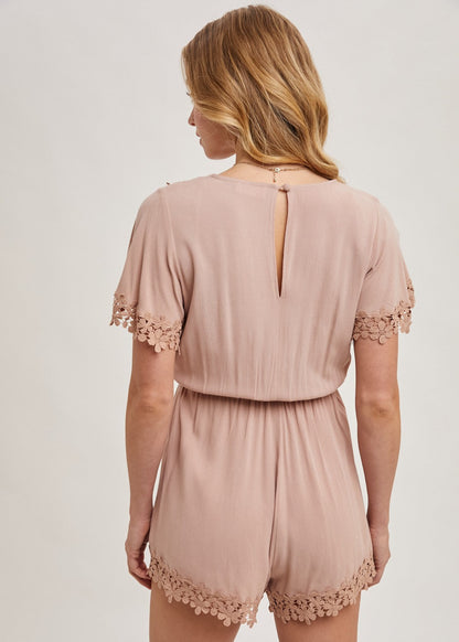 The wrap floral lace trimmed drawstring romper combines elegance and comfort, featuring a flattering wrap design adorned with delicate floral lace trim. The adjustable drawstring waist ensures a perfect fit, while the soft, lightweight fabric provides ease of movement.