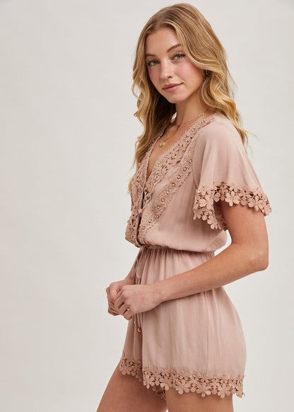 The wrap floral lace trimmed drawstring romper combines elegance and comfort, featuring a flattering wrap design adorned with delicate floral lace trim. The adjustable drawstring waist ensures a perfect fit, while the soft, lightweight fabric provides ease of movement.