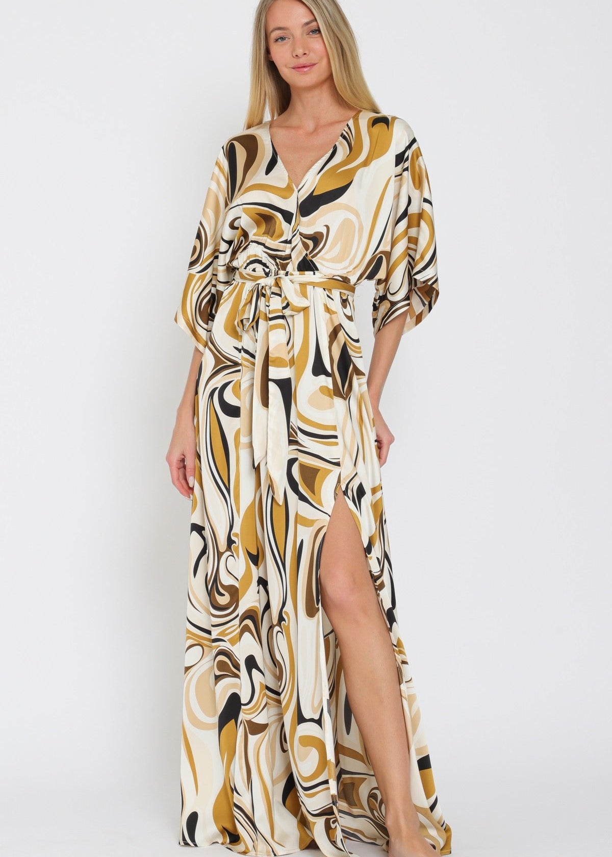 Woman wearing a patterned maxi dress on a white background