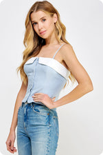 Load image into Gallery viewer, Light chambray contrast color block corset top in suiting twill fabric. This bustier top features contrast fabric detail at bustline, removable adjustable straps, elasticized smocking at back, and button down closure with placket at front. This top can be worn strapless by removing the straps.
