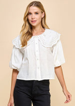 Load image into Gallery viewer, White round neckline, textured collared top with puff sleeves. Featuring a pleated detail and front button down.
