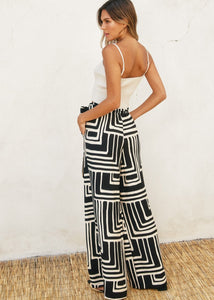 Printed viscose blend wide leg pants. Elastic waist with belt loop. Optional sash belt.