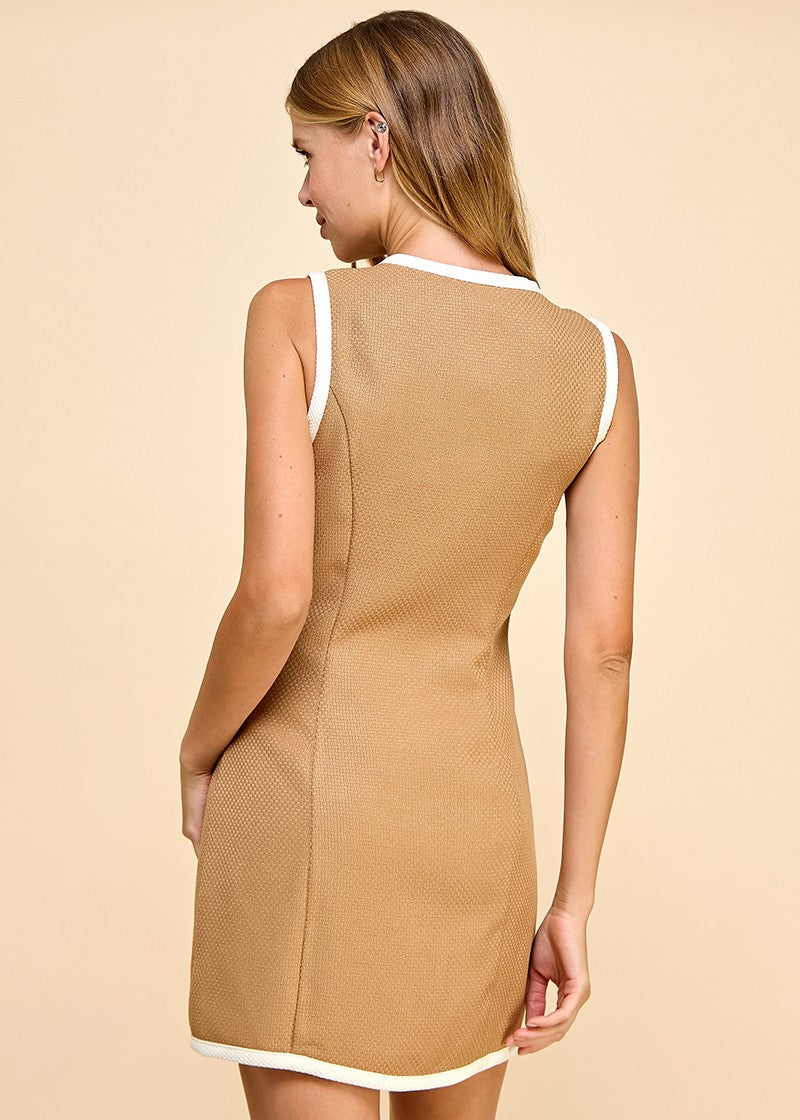Mocha sleeveless, textured fabric dress with button down detail. Featuring a different color trim and faux pockets.