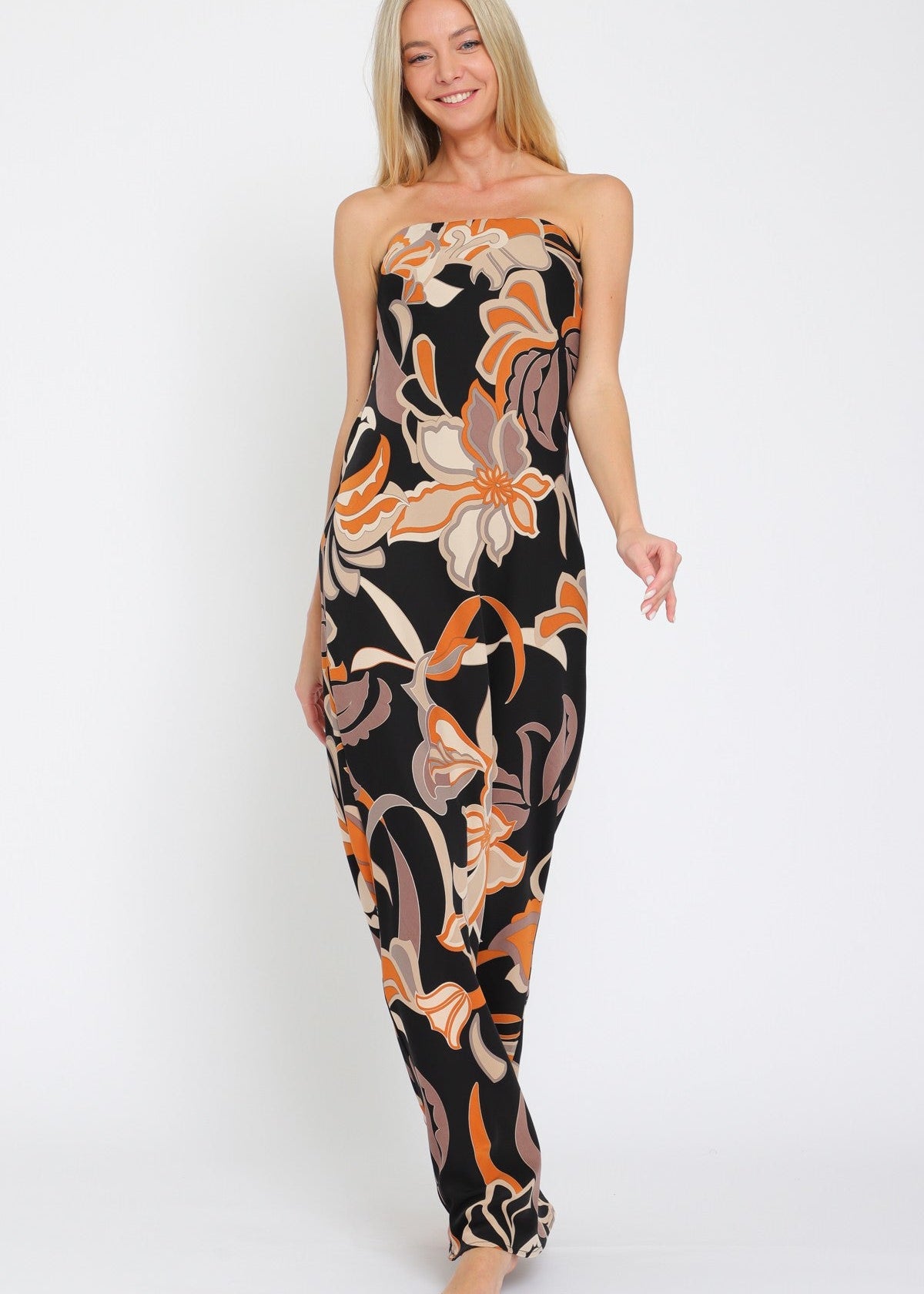 Woman wearing a strapless floral jumpsuit on a white background