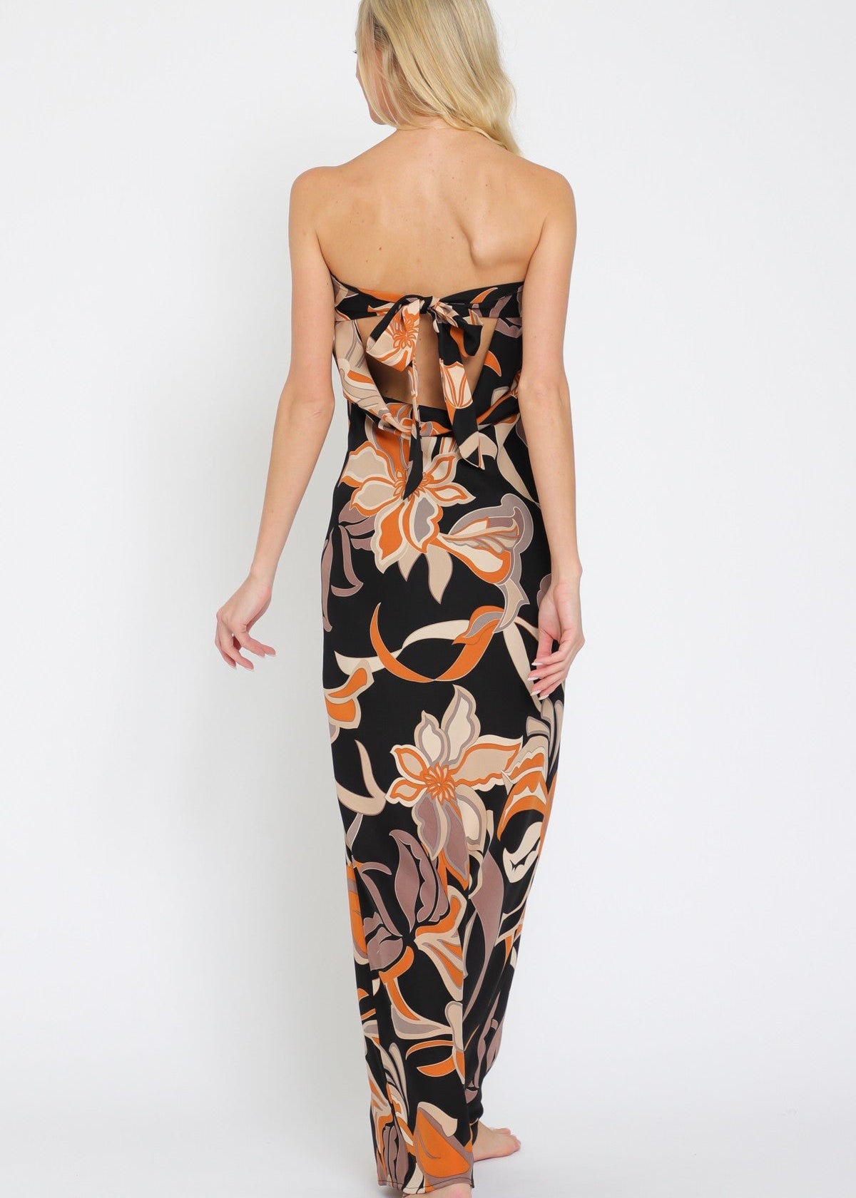 Woman wearing a strapless floral dress on a white background