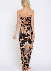 Woman wearing a strapless floral dress on a white background