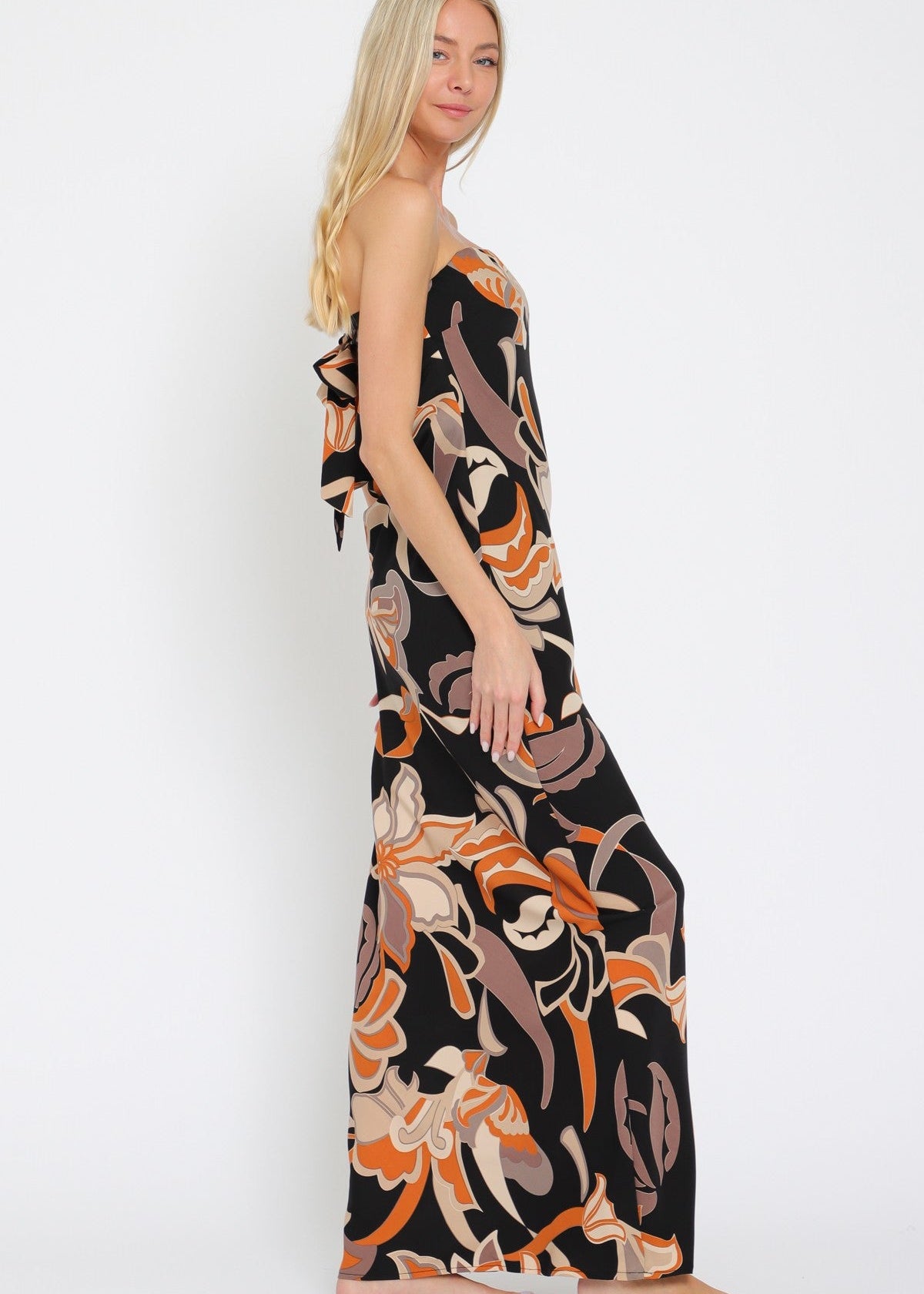 Woman wearing a floral maxi dress on a white background