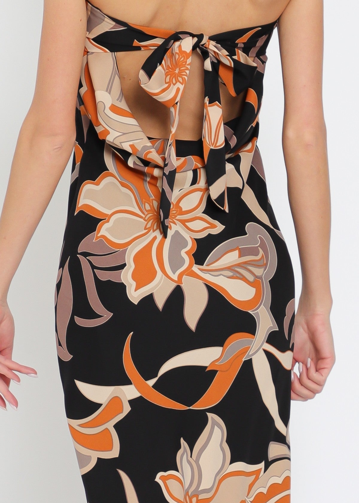Floral patterned strapless dress with a high slit on a white background