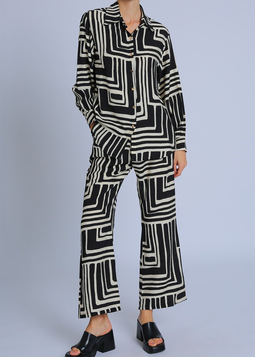 Black and white contrast geometric printed top and pants set. Button up long sleeve top with matching pants.