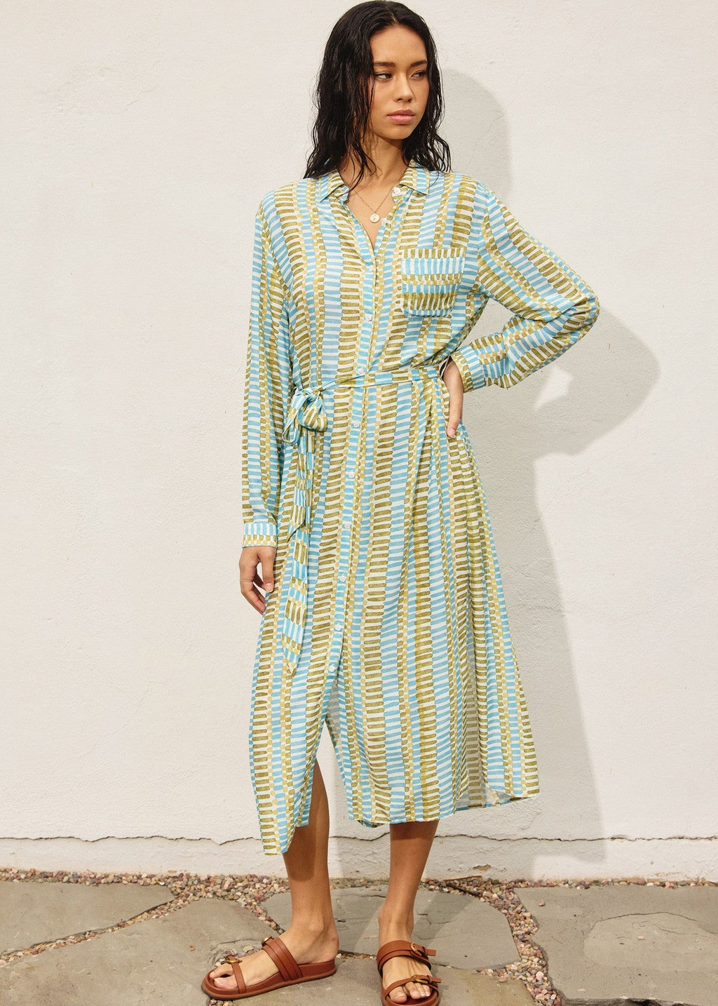 Tropical breeze print longline dress. Features button down closure, side slit detail and side pockets.
