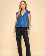 Load image into Gallery viewer, A denim sleeveless top featuring a collared neckline and a wide peplum hem, adding a touch of elegance and flair.
