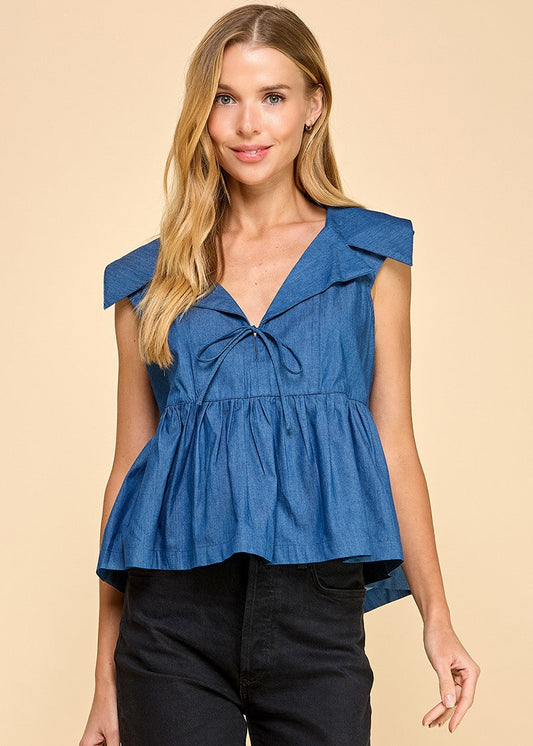 A denim sleeveless top featuring a collared neckline and a wide peplum hem, adding a touch of elegance and flair.