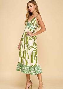 Abstract print midi dress featuring a V-neckline, adjustable spaghetti straps, and a ruffle hem.