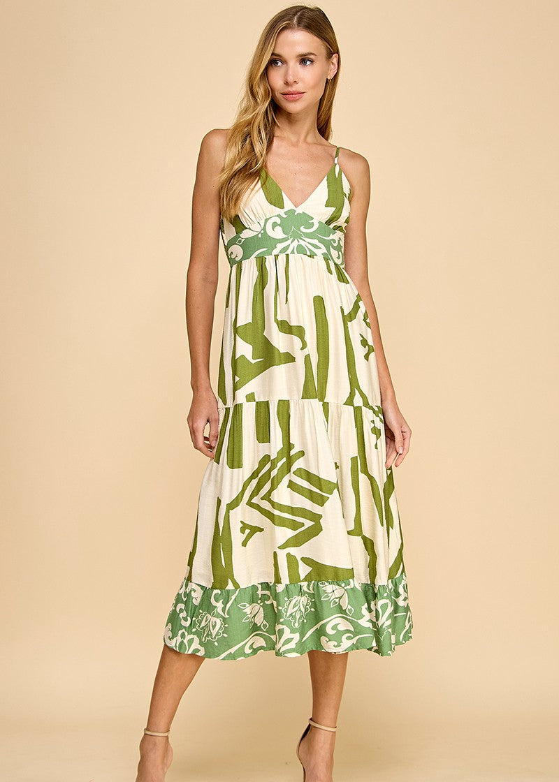 Abstract print midi dress featuring a V-neckline, adjustable spaghetti straps, and a ruffle hem.