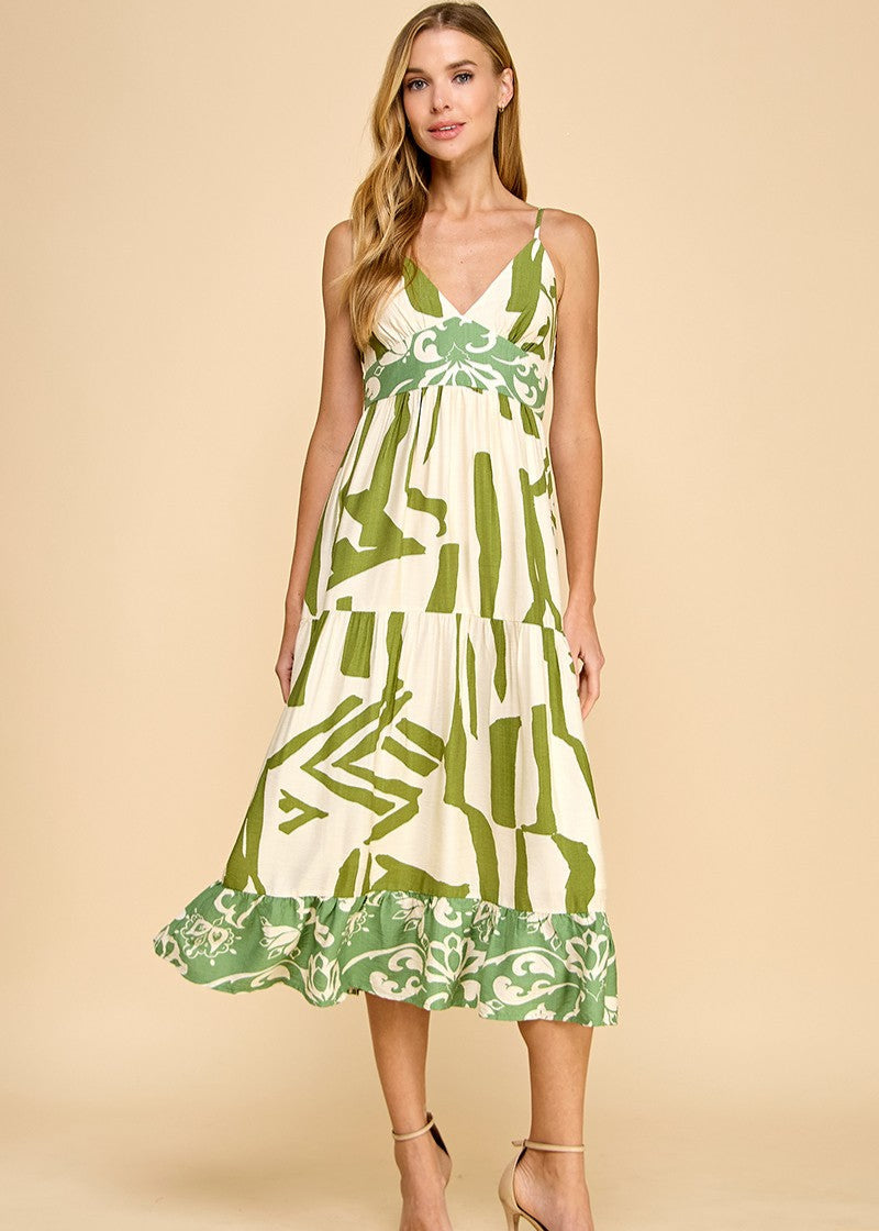 Abstract print midi dress featuring a V-neckline, adjustable spaghetti straps, and a ruffle hem.
