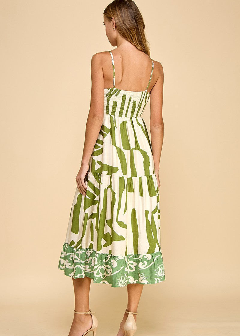 Abstract print midi dress featuring a V-neckline, adjustable spaghetti straps, and a ruffle hem.