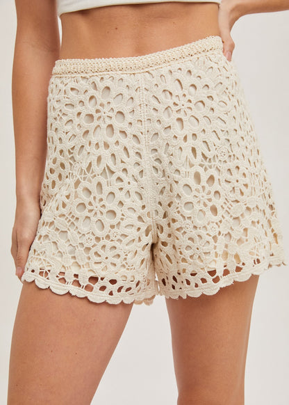 Natural crochet shorts with lining, offering a stylish and breathable design perfect for warm-weather wear. The intricate crochet pattern adds a touch of elegance, while the soft lining ensures comfort and coverage. Ideal for casual outings, beach days, or pairing with your favorite summer tops for a chic look.