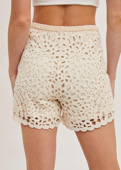Natural crochet shorts with lining, offering a stylish and breathable design perfect for warm-weather wear. The intricate crochet pattern adds a touch of elegance, while the soft lining ensures comfort and coverage. Ideal for casual outings, beach days, or pairing with your favorite summer tops for a chic look.