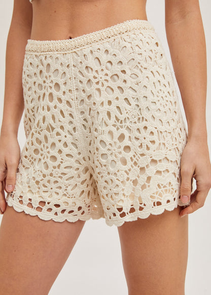 Natural crochet shorts with lining, offering a stylish and breathable design perfect for warm-weather wear. The intricate crochet pattern adds a touch of elegance, while the soft lining ensures comfort and coverage. Ideal for casual outings, beach days, or pairing with your favorite summer tops for a chic look.