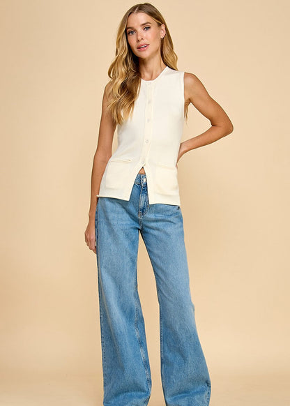 Cream knit button-up vest featuring front pockets for a versatile and stylish look.