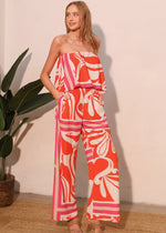 Load image into Gallery viewer, The Sicilia Scarf Cascade Strapless Jumpsuit is a chic and sophisticated one-piece ensemble that combines elegance with modern flair. Featuring a strapless design and a cascading detail, it creates a flattering silhouette while offering effortless movement.
