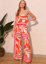 Load image into Gallery viewer, The Sicilia Scarf Cascade Strapless Jumpsuit is a chic and sophisticated one-piece ensemble that combines elegance with modern flair. Featuring a strapless design and a cascading detail, it creates a flattering silhouette while offering effortless movement.
