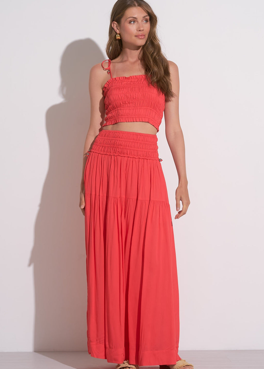 Two piece red coral set. High waisted skirt with matching top that ties at each shoulder.